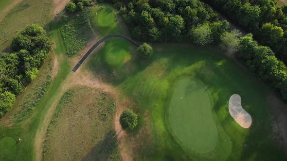 Green golf fields from bird's eye view alt