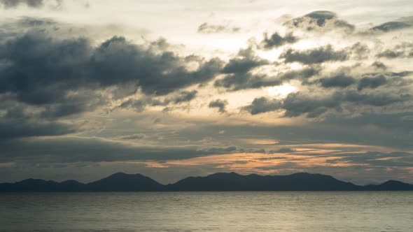 Beautiful sunset timelapse. Sun is setting behind mountains, Ko Lanta, Thailand. alt