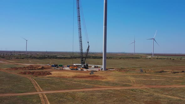 Drone Footage of the Construction Site Under a Huge Wind Turbine 