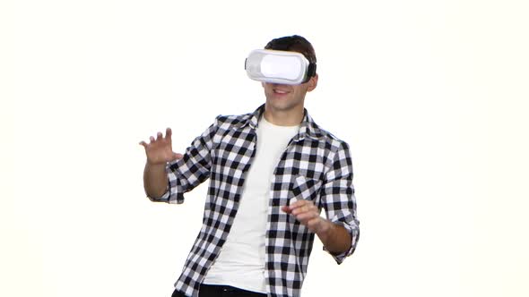 Man Playing Online Game Wearing Virtual Reality Glasses. White Background