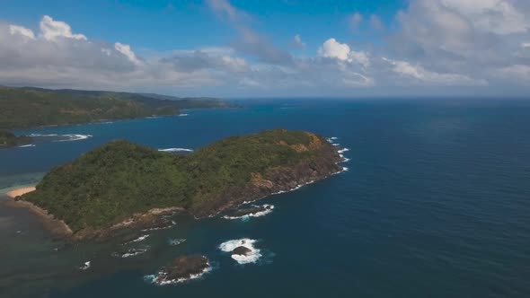 Seascape with Tropical Island, Rocks and Waves. Catanduanes, Philippines.