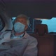 Senior Man in Protective Face Mask Sitting in Taxi - VideoHive Item for Sale
