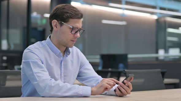 Young Man Loss on Smartphone