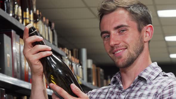 Handsome Man Smiling To the Camera Holding Wine Bottle