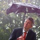 Businessman Sheltering Underneath a Broken Umbrella in the Rain - VideoHive Item for Sale