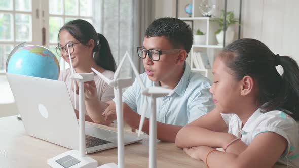 Asian Children Using Laptop Computers To Program Wind Turbines, Learning About Eco-Friendly