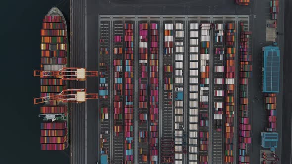 Loading and discharging huge container ship in port.