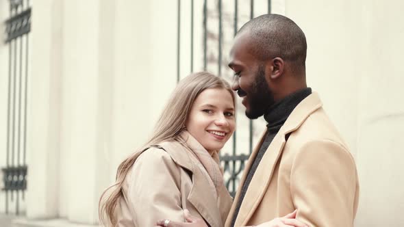 Affectionate Young Woman Hugging Her Boyfriend in the City