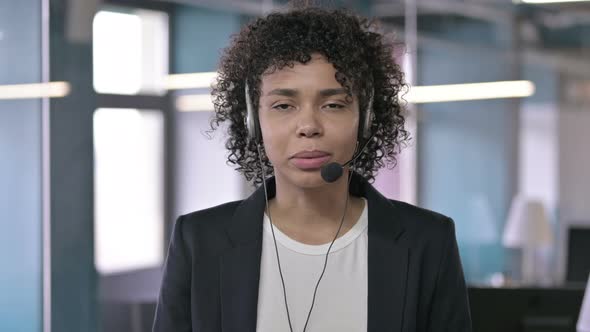 Portrait of Serious African Businesswoman Talking Through Head Set