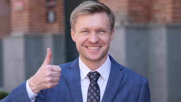 Thumbs Up by Businessman