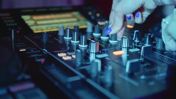 DJ Hands Control Sound Console for Mixing Music in Disco Club