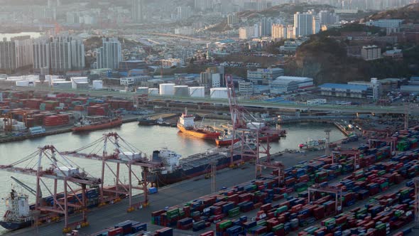 Timelapse Coloured Containers in Busan Port with Cranes