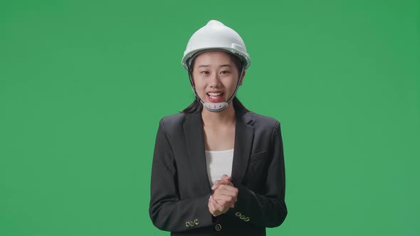 Smiling Asian Female Engineer Talking In The Green Screen Studio