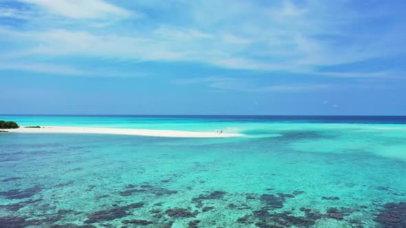 Aerial panorama of tranquil island beach journey by blue green ocean with white sand background of a