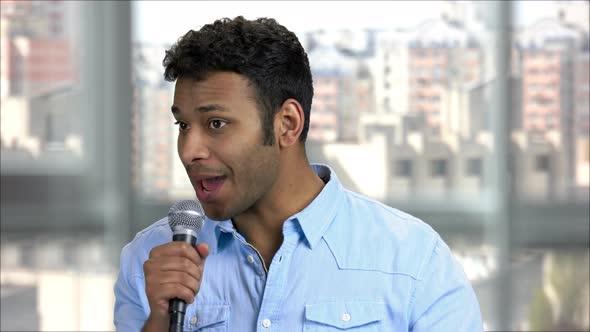 Young Indian Entertainer Talking with Audience Using Microphone