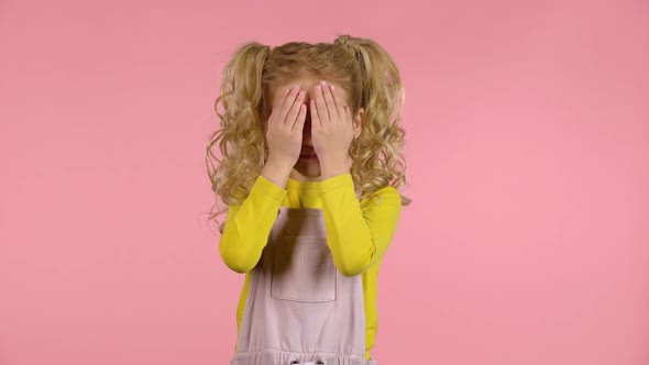 Beautiful Cute Female Child Is Hiding Face with Fingers