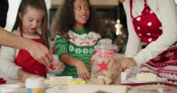 Family baking cookies for Christmas together