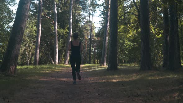 Sport Girl Running In City Park On Sunny Summer Day