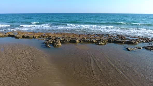 Shallow Rocky Reef Between the Sea and the Beach