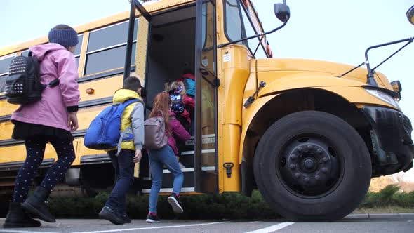 Diverse Elementary Age Kids Getting on School Bus