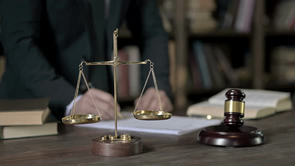 Close Up Shoot of Judge Hand Reading Paper in Court Room Table