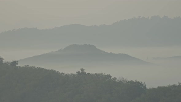 Mountain Peaks Rise Above The Mist.