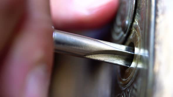 Key Inserted in a Key Hole in the Wooden Door and Turned By Hand