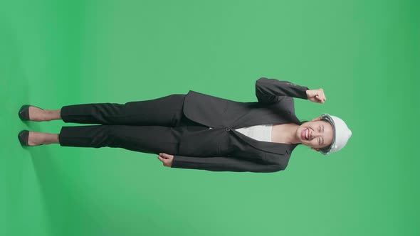 Full Body Of Female Engineer With Safety Helmet Celebrating While Standing On Green Screen