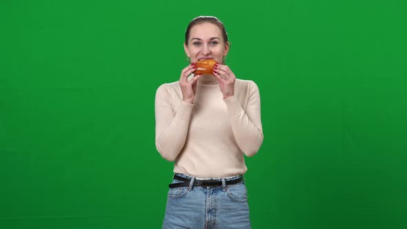 Slim Woman Eating Delicious Unhealthy Food on Green Screen