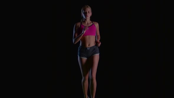 Woman Young Running on the Black Background. Slow Motion