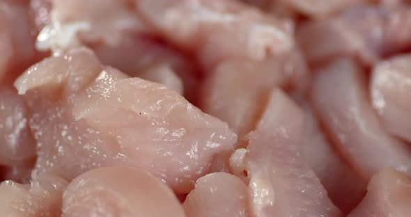 Pieces of Raw Chicken Fillet Rotate Slowly. 