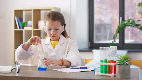 Girl with Test Tubes Studying Chemistry at Home