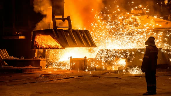 Steelworker near a blast furnace with sparks. Cinemagraph.