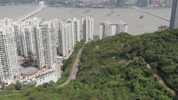 Tilt reveal drone shot of Macau skyline over highrise apartments in Taipa