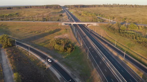 Aerial View. Interchange on the Intercity Highway. Cars and Trucks Travel in Different Directions