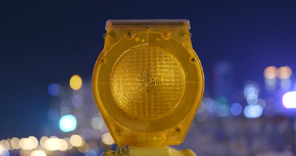 Yellow road construction warning light at night