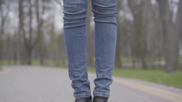 Camera Moving Up From Feet To Face of Slim Beautiful Caucasian Woman Standing on Park Alley Wearing