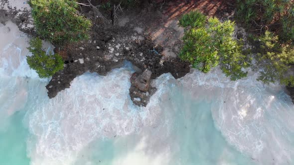 Aerial Top of Tidal White Waves Hit the Coral Reef on Rocky Coastline Zanzibar