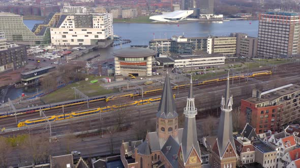 Trains Arriving and Departing Amsterdam Centraal Station in the Evening Aerial