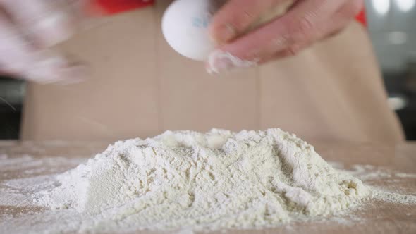 Baker Is Making a Dough on the Table. Hands Close-up