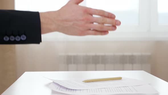 Manager and Client Shake Hands Above Contract in Office