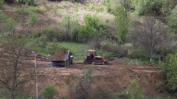 Timelapse: bulldozer flattening surface on further construction site