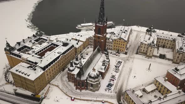 Zoom out cinematic aerial view of historic Riddarholmen church located in Old Town (Gamla Stan) of S
