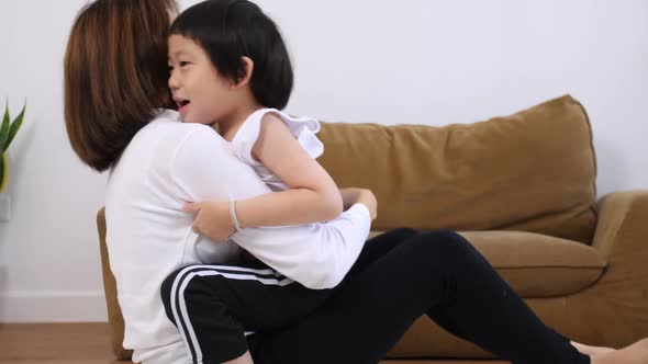 Young mother with her little son spending time together at home.