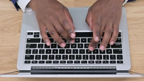 Top View of African Businessman Typing on Laptop