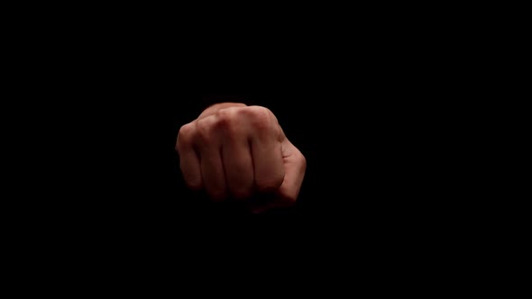 Male hand showing gesture isolated on black background