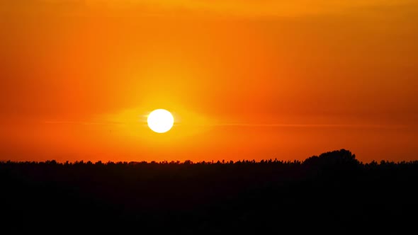 Sunset in the Yellow Sky. Timelapse. Big Bright Yellow Sun Moves Down.