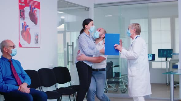 Excited Young Couple Receiving Good From Doctor