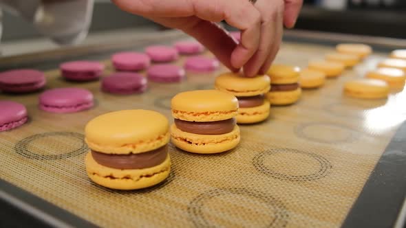 The Pastry Chef Assembles Macarons with Chocolate Cream