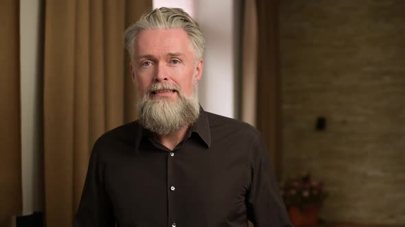 gray-haired bearded adult man is afraid of something